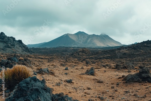 A dramatic landscape view with mountainous terrain under cloudy skies