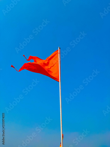 saffron colour flag with blue sky background.