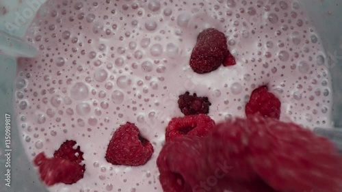 Pouring Frozen Raspberries into a Blender