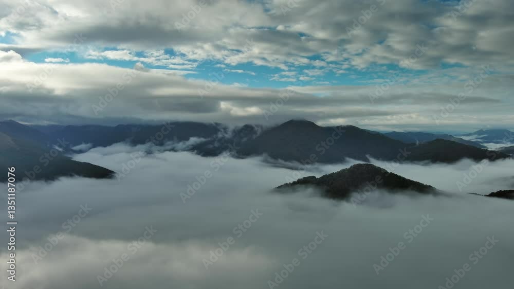 Flying between the clouds. Aerial view of clouds and mountains at sunrise. Traveling by air background, 4k Flying between the clouds. Aerial view of clouds and mountains at sunrise. Traveling by air background, 4k