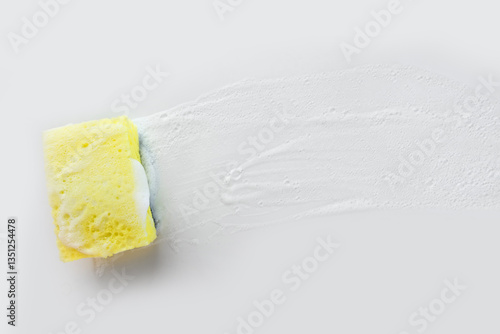 kitchen sponge with foam on a white