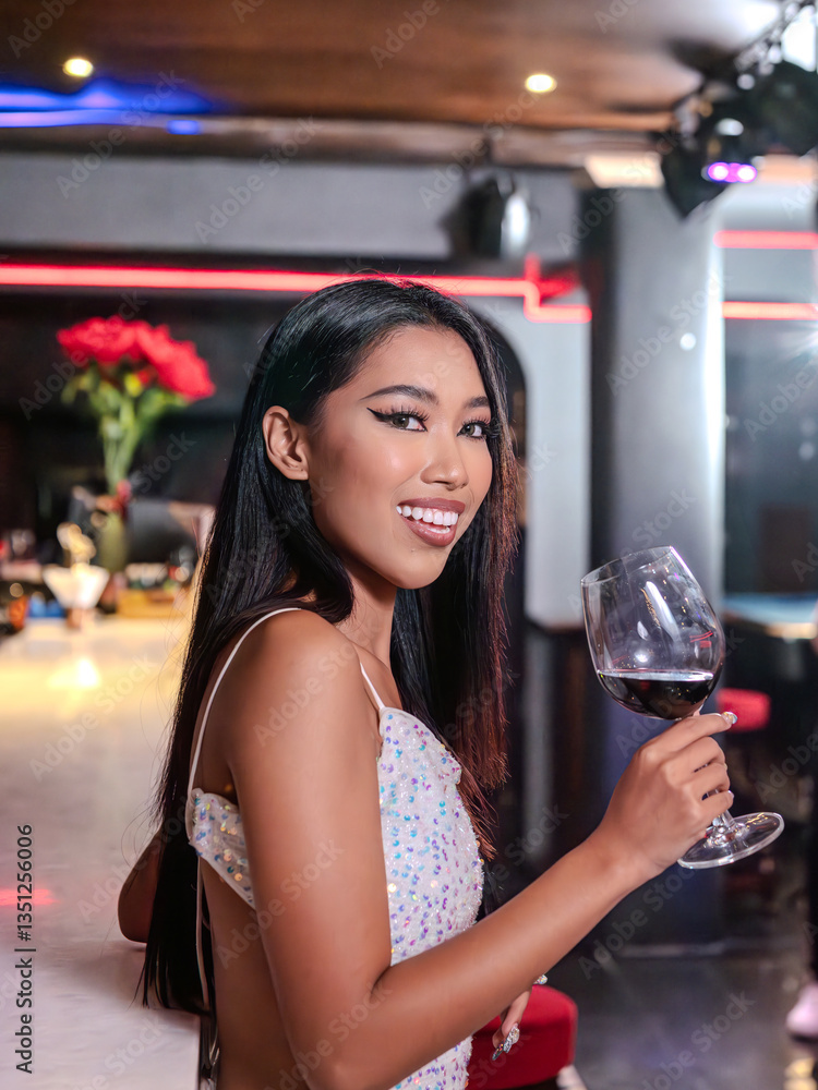 Woman is holding a glass of red wine. Bar, Restaurant and beverage, Night club concept.
