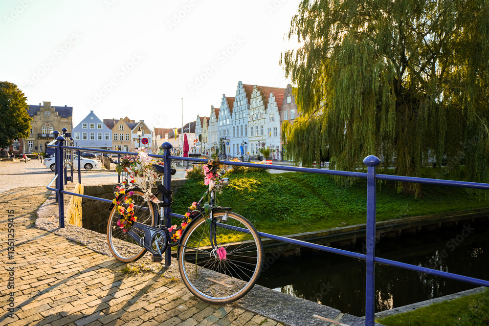 Fototapeta premium View of the canal and surrounding area in Friedrichstadt, a climatic health resort in North Frisia. 