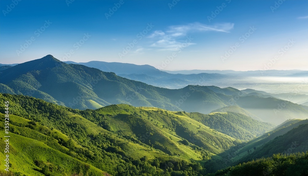 Obraz premium a scenic view of a mountainous landscape with lush green hills and a clear blue sky the hills are covered with dense forests and mist is visible in the distance creating a serene atmosphere
