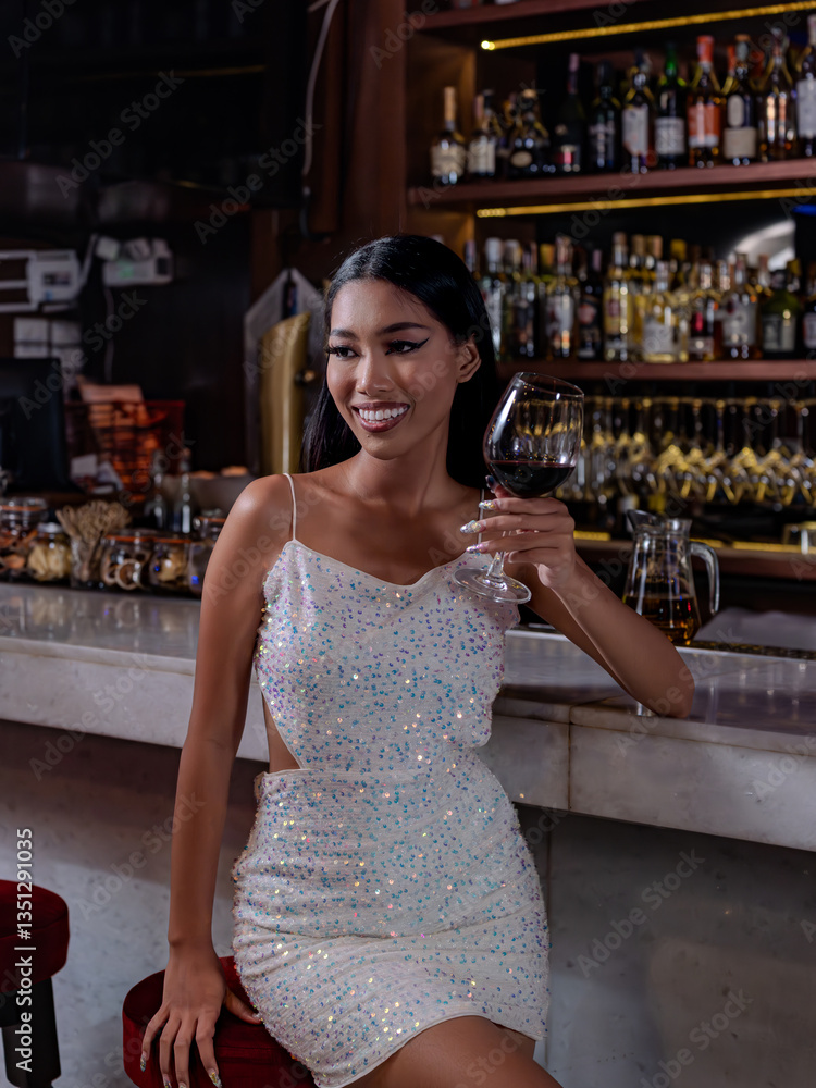 Woman is holding a glass of red wine. Bar, Restaurant and beverage, Night club concept.