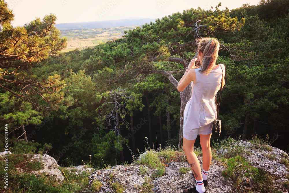 Obraz premium girl in blue dress do a photo of nature at the mountains