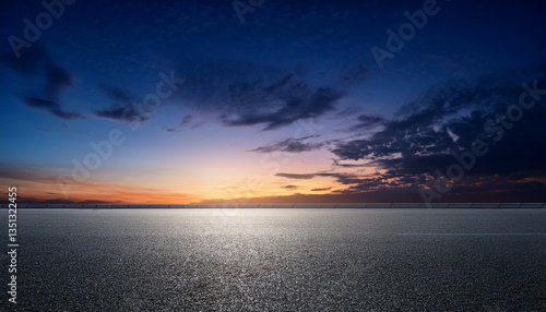 black asphalt floor heritage and darkish blue night time sky sunset horizon with diffused clouds