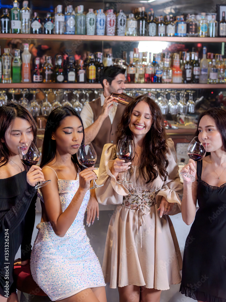Happy People Group clink wine glasses for cheers in night club at counter. Celebration, friends and party concept.