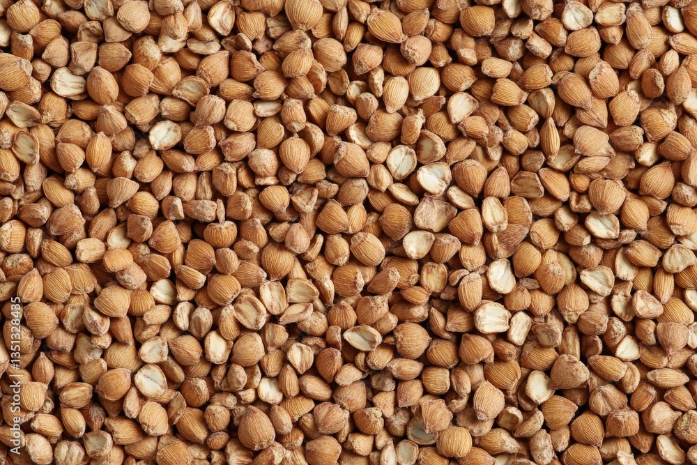 An overhead view displays a lot of brown buckwheat kernels An overhead view displays a lot of brown buckwheat kernels