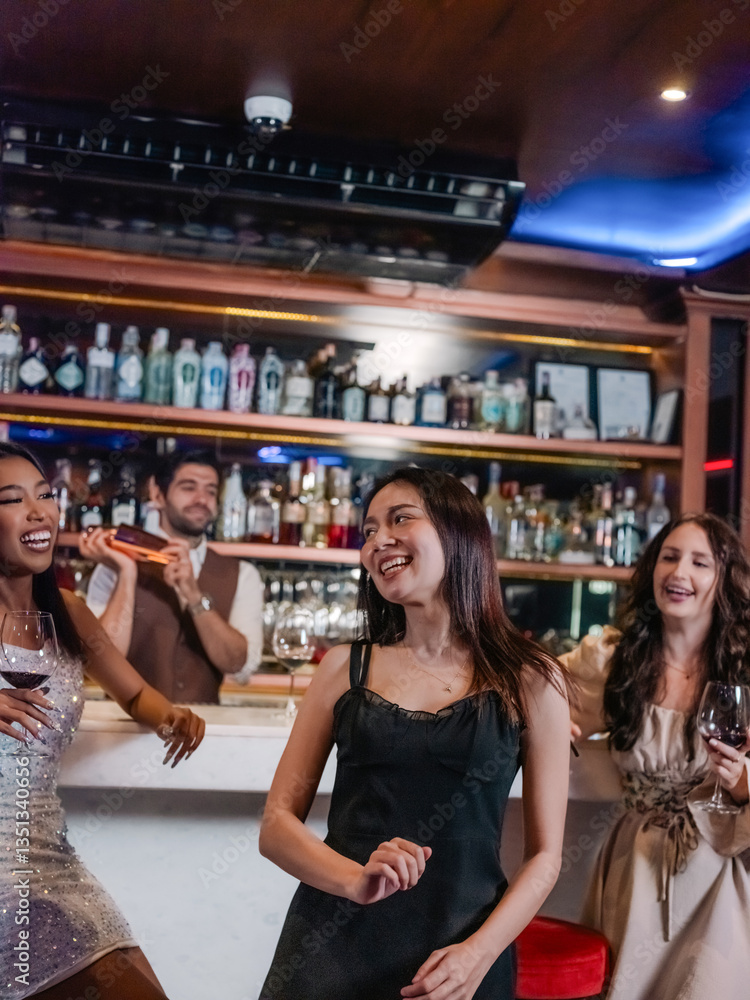 A group of young people dancing happily in a nightlife in a pub, restaurant, and bar.