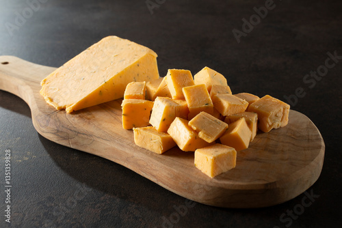 A view of a pile of double gloucester cheese chunks.