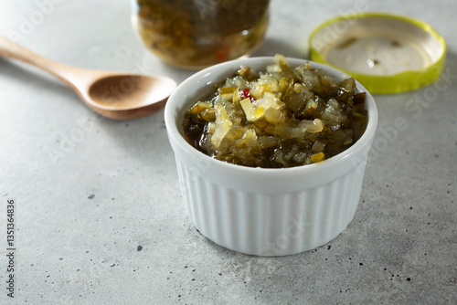 Картината върху платно A closeup view of a condiment cup of sweet relish.
