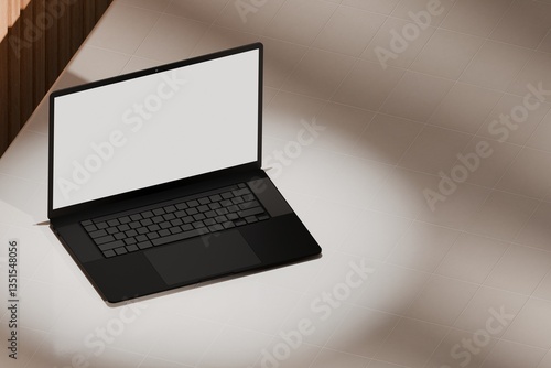 High end laptop on tile studio floor and acoustic backdrop. Blank mockup template screen. Spotlight from above