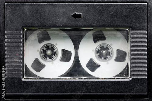 Inside the cassette door is a compact cassette with a reel-to-reel look