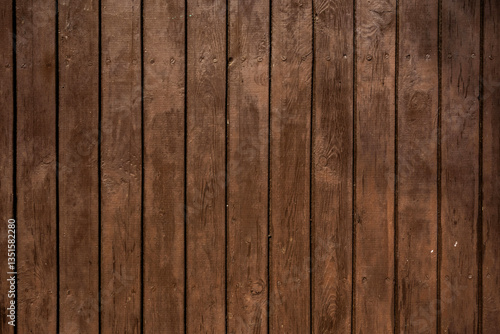 Old Rough Wooden Wall Painted Brown With Visible Wood Structure And Rings. Brown Wooden Boards Arranged Vertically. Close up. Weathered Wood.