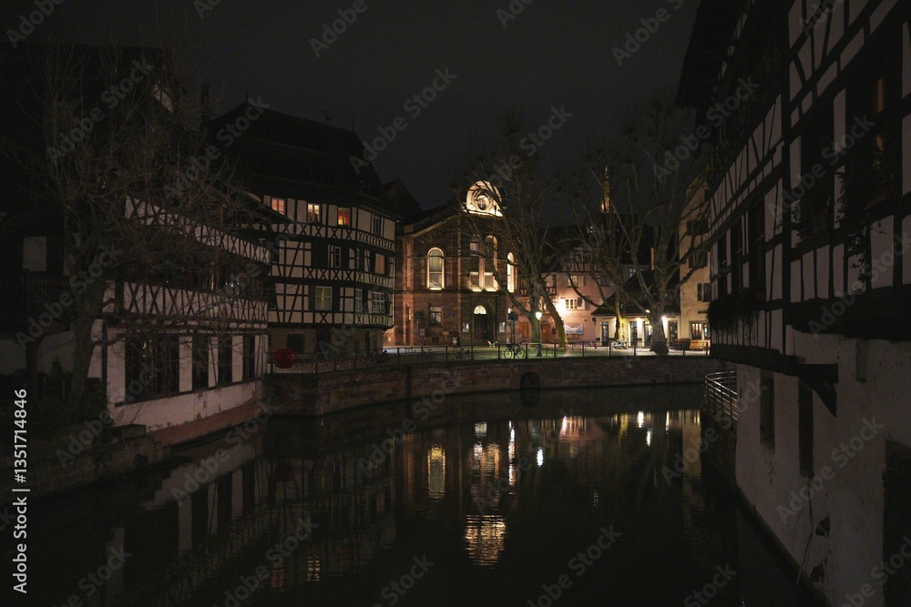 Fototapeta premium Canal reflections and timbered houses in Strasbourg at night