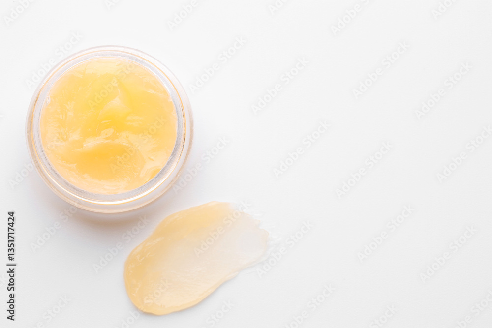 Jar and sample of lip balm on white background, top view. Space for text Jar and sample of lip balm on white background, top view. Space for text