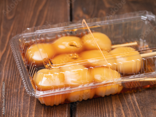 Obraz na płótnie プラスチック容器に入っている和菓子。甘い醤油タレの