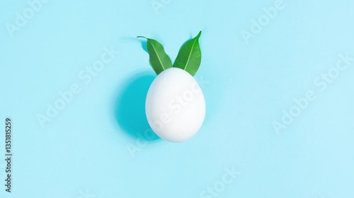 Wallpaper Mural White egg decorated with green leaves, symbol of Easter Bunny. Green leaves move cyclically like ears of an Easter bunny. Minimal concept. Greeting holiday card. Stop motion animation. Torontodigital.ca