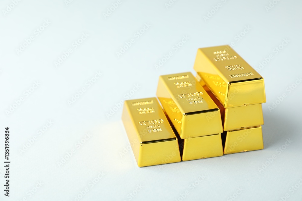 Shiny gold bars on light background, closeup. Space for text Shiny gold bars on light background, closeup. Space for text