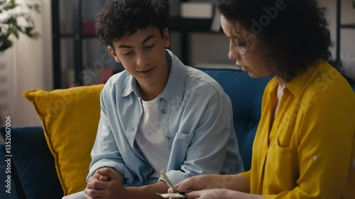 Wallpaper Mural Mother giving pocket money to her pleased teen son, offering financial support Torontodigital.ca