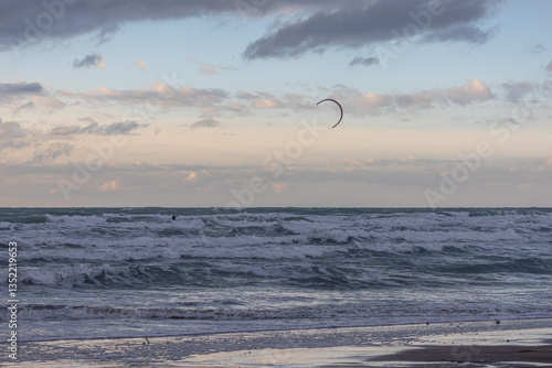 Kitesurfing is a sport based on movement under the influence of gravity created by a kite. Riding on the water surface on a special board due to the force of the wind during a storm at sea.