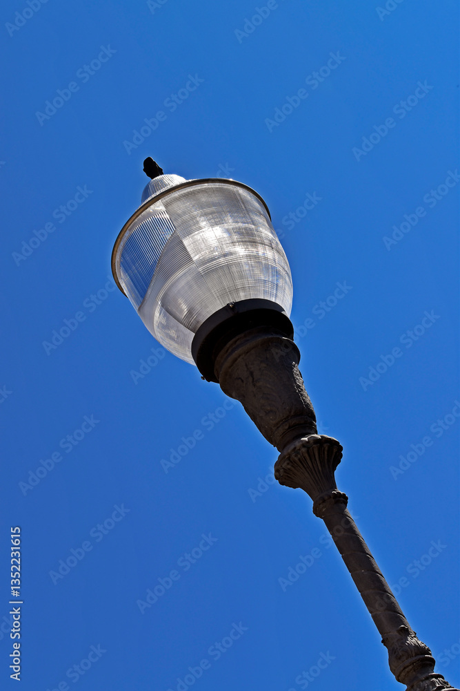 Antique street lamp against a blue sky on Quinta da Boa Vista, Rio de Janeiro, Brazil
