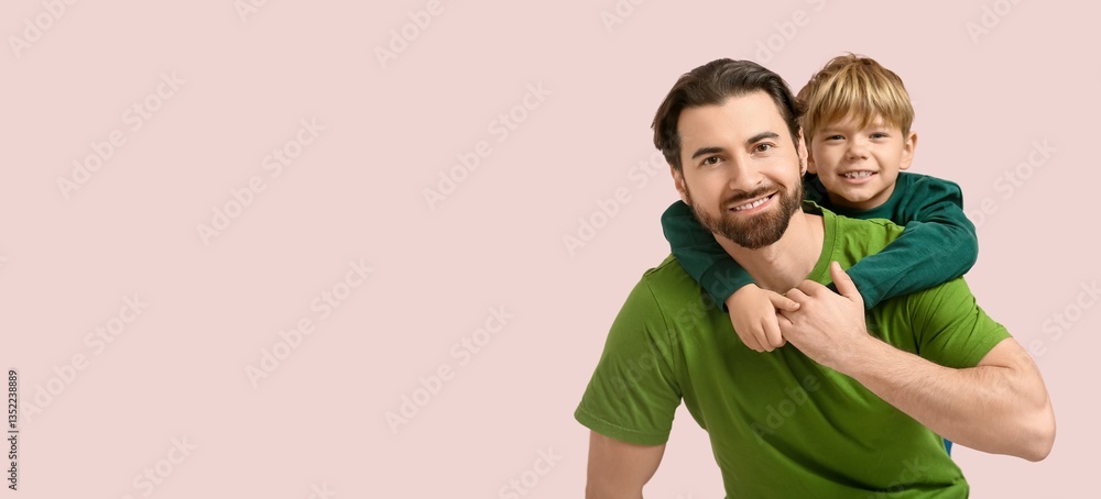 Smiling boy hugging his dad on pink background with space for text. Father's Day Smiling boy hugging his dad on pink background with space for text. Father's Day