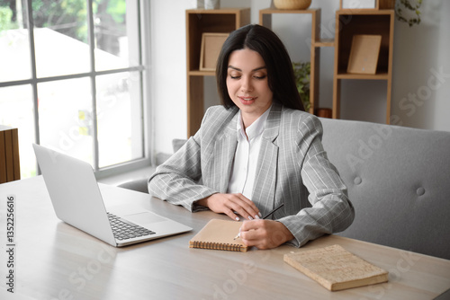 Beautiful woman writing not...