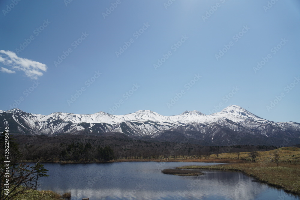 Snow-covered Shiretoko mountains and reflecting lake Snow-covered Shiretoko mountains and reflecting lake