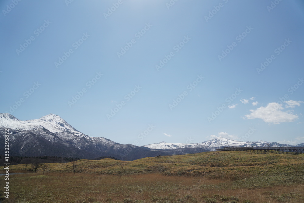 Fototapeta premium Snow-covered Shiretoko mountains and blue sky