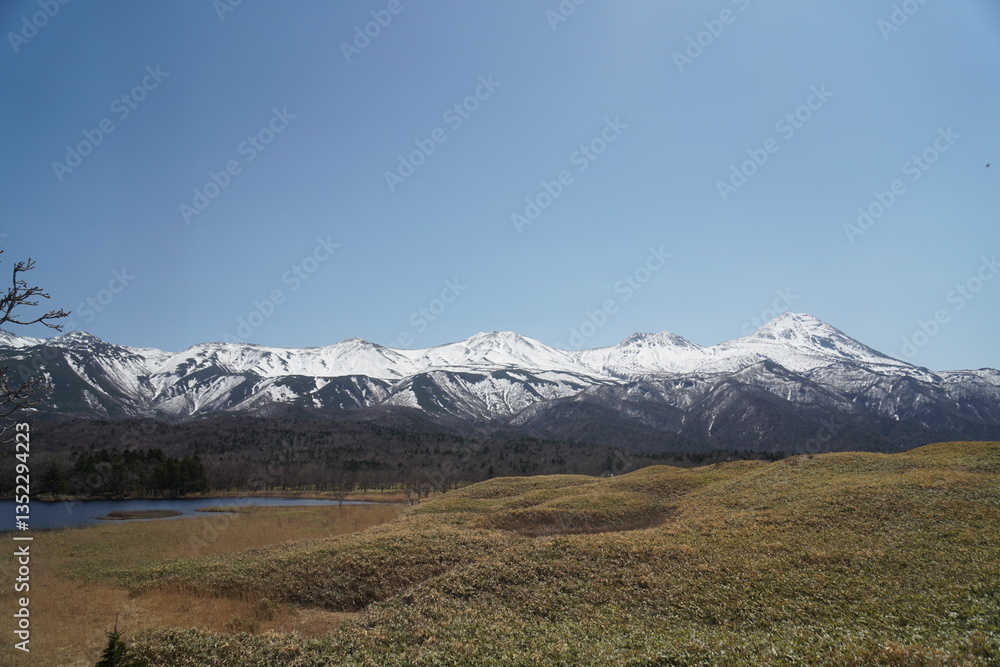 Fototapeta premium Snow-covered Shiretoko mountains and blue sky