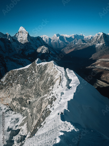 Snowy summit ridge of Island peak with mountaineers