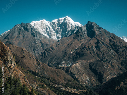Rocky foreground and mountain peaks under clear sky