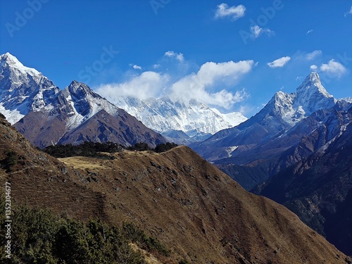 Mountain river flowing between forested slopes with snow-capped peaks