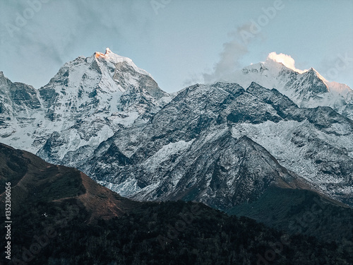 Rocky foreground and mountain peaks under clear sky
