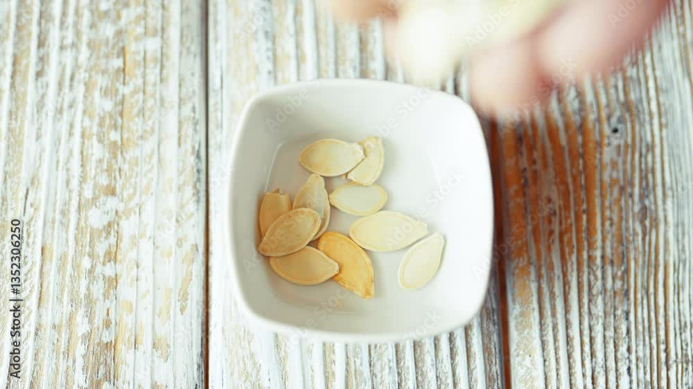 The pumpkin seeds in a plate close-up. Healthy food concept,healthy nutrition.