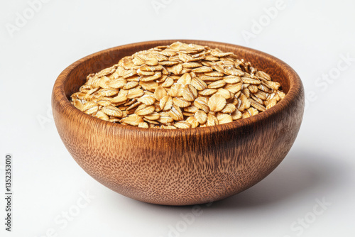 Wooden bowl filled with oats, surrounded by scattered berries and a silver spoon, set against a rustic background of a wooden table and soft natural light.