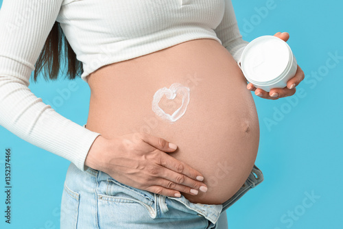 Pregnant woman with jar of ...