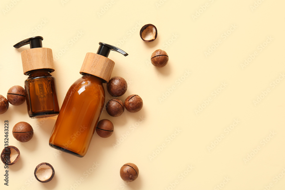 Macadamia nuts and bottles of cosmetic product on beige background Macadamia nuts and bottles of cosmetic product on beige background