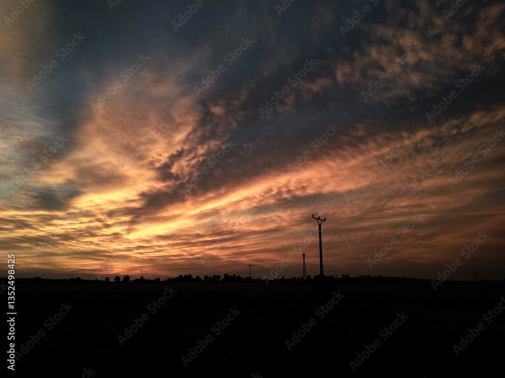 Stunning orange and blue sunset illuminating the countryside