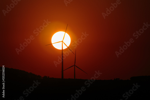 Wind Turbines And Sun At Sunset - Renewable Energy Concept
