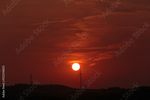 Wind Turbines And Sun At Sunset - Renewable Energy Concept