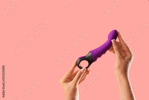 Woman with vibrator on pink...