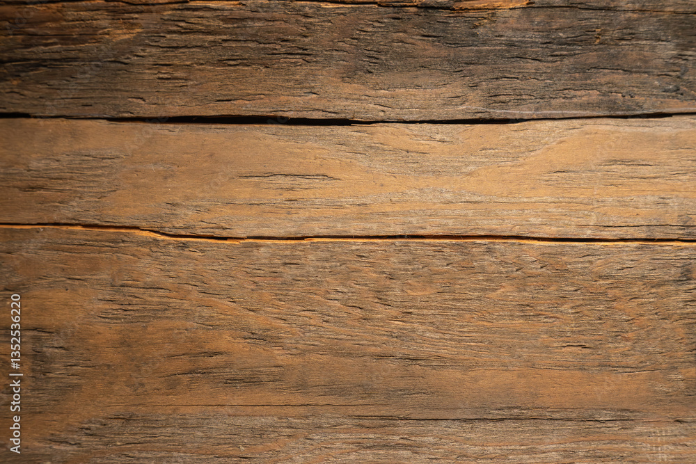 Fototapeta premium A photo of the texture of a wooden board with cracks and knots.The background is made of antique boards.