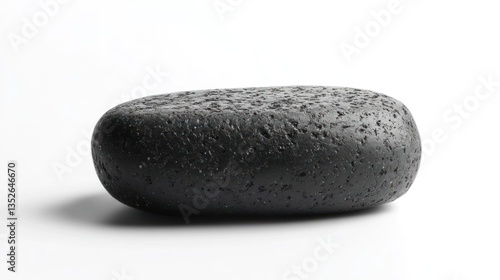 Smooth shiny black pebble or stone with water droplets reflecting on its textured minimalist surface  Tranquil serene and calming abstract natural background or wallpaper design