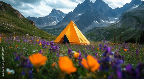 Bright Yellow Tent Stands in Vibrant Flower Field Under Rugged Mountain Peaks...