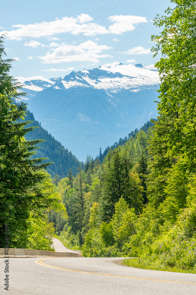 Fototapeta premium Majestic mountain road with forest foreground in Vancouver, Canada, North America. Day time on June 2024