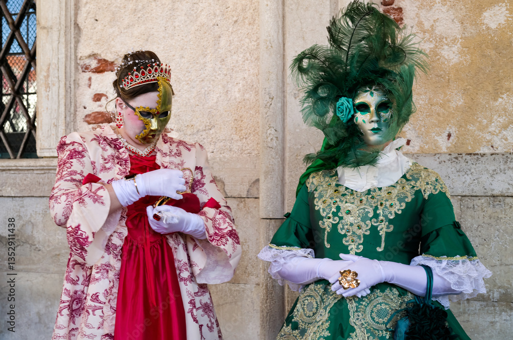 Venice, Italy - People dressed in carnival masks are photographed by tourists in the scenery of the ancient Venetian palaces Venice, Italy - People dressed in carnival masks are photographed by tourists in the scenery of the ancient Venetian palaces