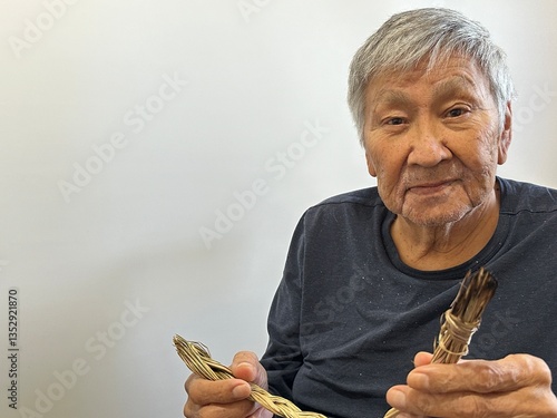 indigenous elder holding a braid of sweet grass